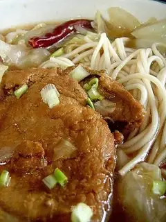 Noodles with large steak in soup