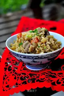 The lamb's hand grabs rice