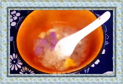 A silver spoon of colored white fruit