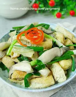 stir-fried tofu with garlic sprouts and mushrooms