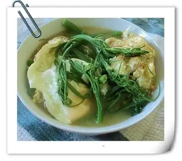 Fried eggs and soup with asparagus