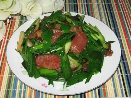 stir-fried garlic sprouts with cured meat