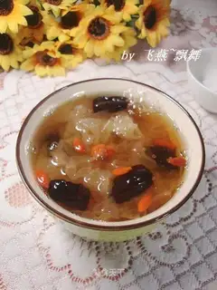 A silver spoon with red dates