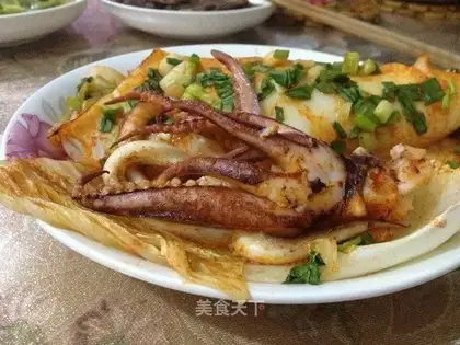 A roasted squid roll of golden mushrooms
