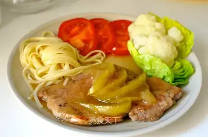 A pork chop with apple sauce