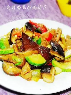 Fried zucchini with pork slices of mushroom