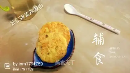 The baby eats shrimp and vegetables
