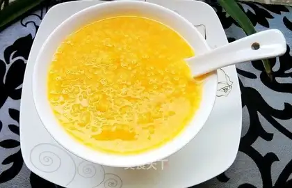 Baby eats the pumpkin porridge with salmon