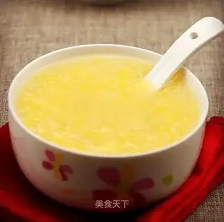 Baby eats carrot corn and apple porridge