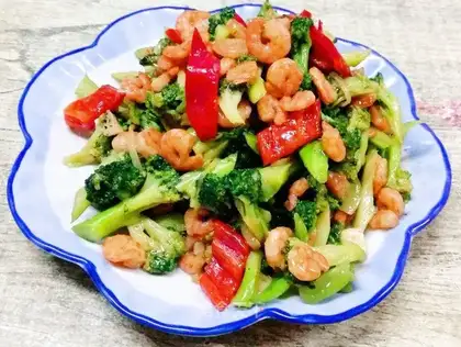 The broccoli rolls the shrimp