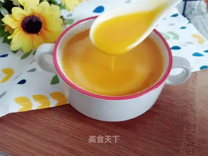 The baby feeds the pumpkin rice paste