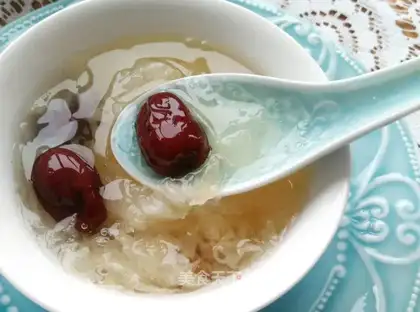 A silver spoon with red dates