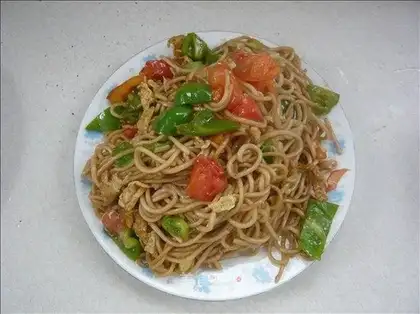 Fried noodles with tomato, green pepper and egg