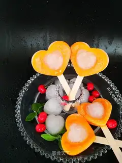 A mango popsicle with a heart