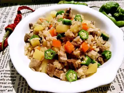 The lamb's hand grabs rice