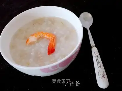The baby eats meat oatmeal