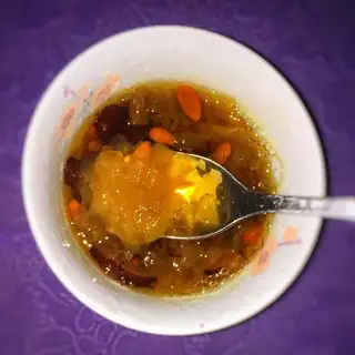 A silver spoon with red dates