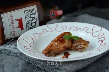 A chicken wing with cranberry sauce
