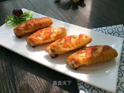A fried chicken wing with honey