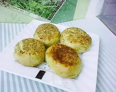 Baking sesame cakes in an iron pot
