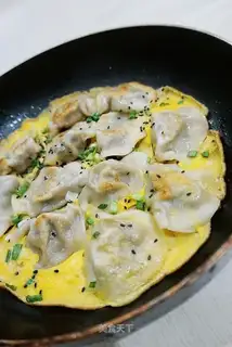 Fried dumplings holding eggs