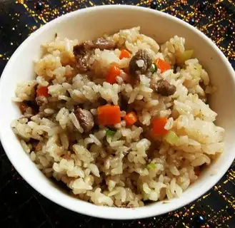 The lamb's hand grabs rice