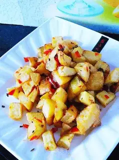 stir-fry diced potatoes with chopped pepper and dry pepper