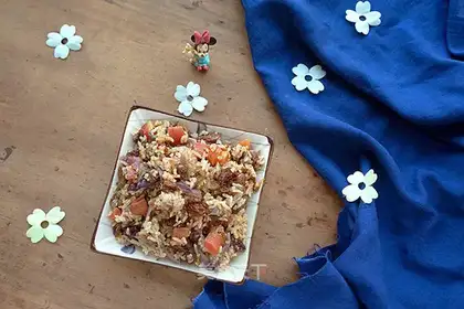 The lamb's hand grabs rice