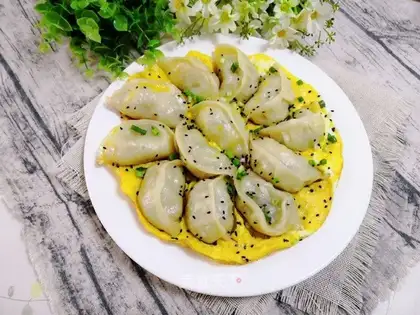 A radish fan hugs an egg dumpling