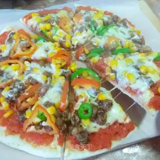 A pan of beef pizza