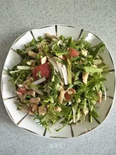 A chicken salad with chrysanthemum tomatoes