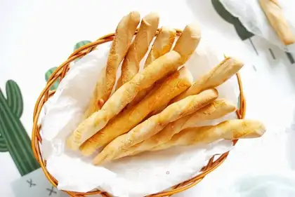 A homemade baby grinds a toothstick cookie
