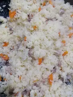 The lamb's hand grabs rice