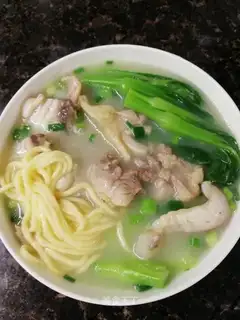 Boiling a handmade carrot egg noodles