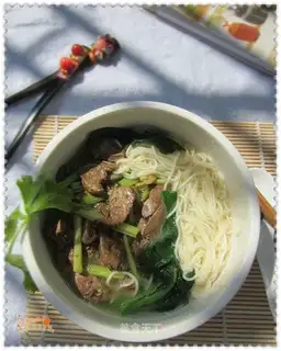 Noodles in soup with celery and duck liver