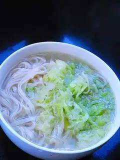 Noodles in hot soup with shredded cabbage
