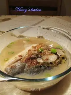 Fish head soup with carrot slices