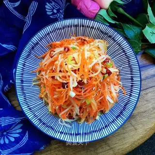 A brown carrot with potatoes