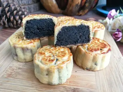 A broad black sesame moon cake