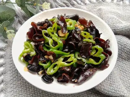 The green pepper is made of black wood