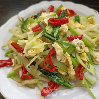 The broccoli has fried eggs