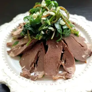 The pig's heart is in his teeth