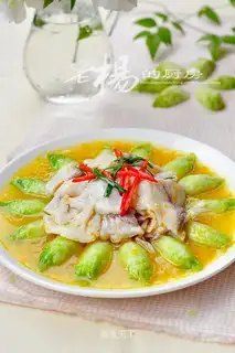 Fish slices in golden soup