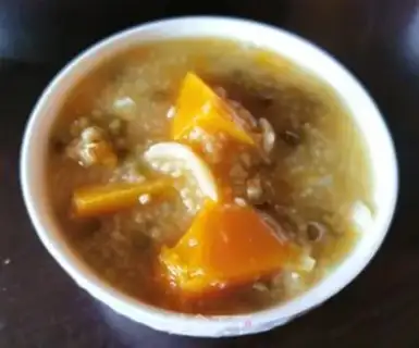 Make Pumpkin green bean lily porridge step 8